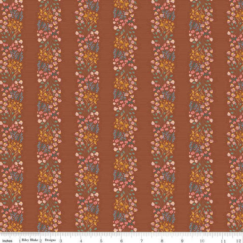 Copper colored quilting cotton fabric with stripes of clustered green, pink, blue, and yellow flowers. 
Cute Little Fabric Shop