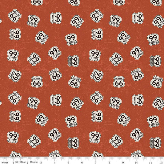 Rust, red colored quilting cotton fabrics with scattered Route 66 signs. 
Cute Little Fabric Shop