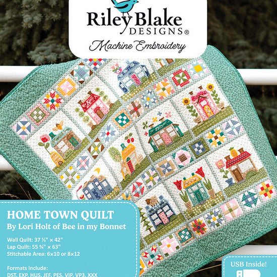 Picture of the Riley Blake Designs Machine Embroidery Home Town Quilt Projects. Pictures a quilt with embroidered houses and states that the USB is inside. 
Cute Little Fabric Shop