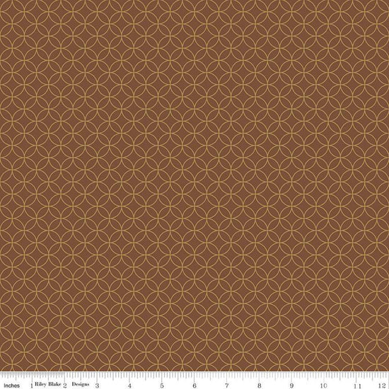 Image of the Autumn Afternoon Pumpkin Seeds  Brown quilting cotton fabric by Heather Peterson for Riley Blake Designs. Features an orange peel geometric design on a brown colored background. 
Cute Little Fabric Shop