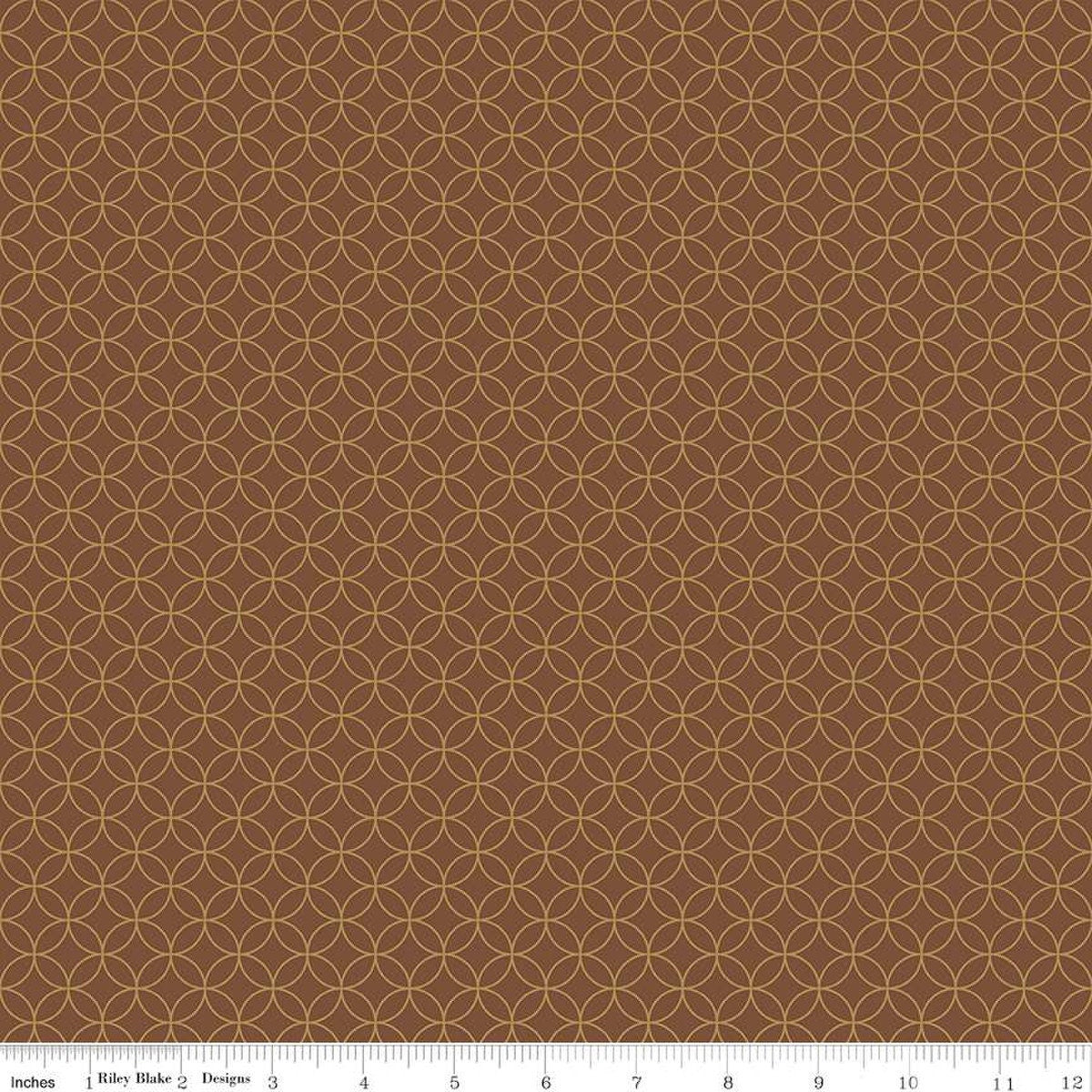 Image of the Autumn Afternoon Pumpkin Seeds  Brown quilting cotton fabric by Heather Peterson for Riley Blake Designs. Features an orange peel geometric design on a brown colored background. 
Cute Little Fabric Shop