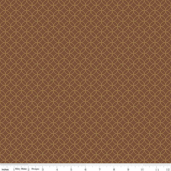 Image of the Autumn Afternoon Pumpkin Seeds  Brown quilting cotton fabric by Heather Peterson for Riley Blake Designs. Features an orange peel geometric design on a brown colored background. 
Cute Little Fabric Shop
