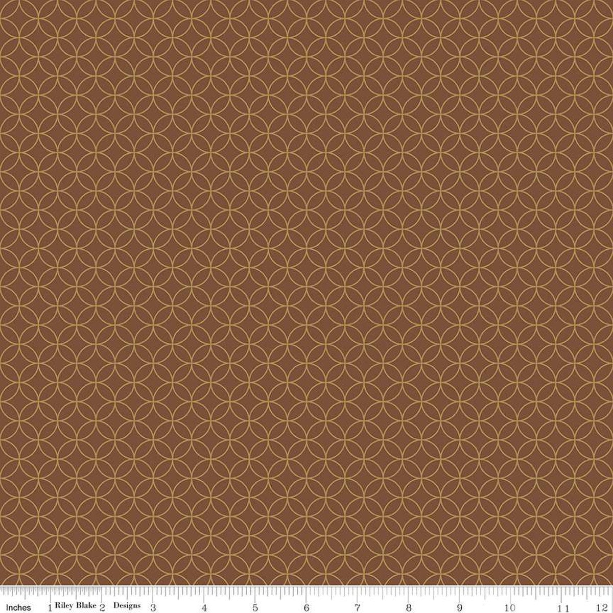 Image of the Autumn Afternoon Pumpkin Seeds  Brown quilting cotton fabric by Heather Peterson for Riley Blake Designs. Features an orange peel geometric design on a brown colored background. 
Cute Little Fabric Shop