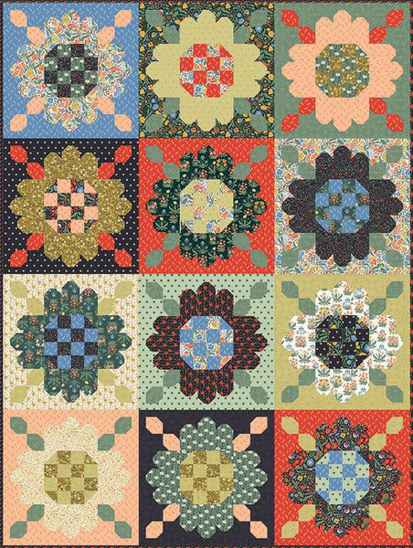 Image of the Zinnia Seeds Sampler Quilt Pattern by Heather Peterson for Riley Blake Designs. Features  pieced flowers in green, red, blue, and beige. 
Cute Little Fabric Shop