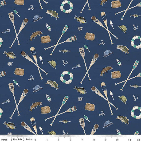 Navy blue quilting cotton fabric featuring Riley Blake Wake at the Lake fabric. This fabric has scattered illustrated paddles, oars, fish, hats, hooks, and bait. 
Cute Little Fabric Shop