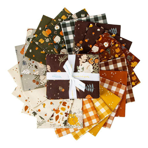 Image of the fat quarter bundle from the Pumpkin Spice collection by Riley Blake Designs. Depicts the main brown fabric on the top, and other brown, orange, and green fabrics surrounding it.
Cute Little Fabric Shop