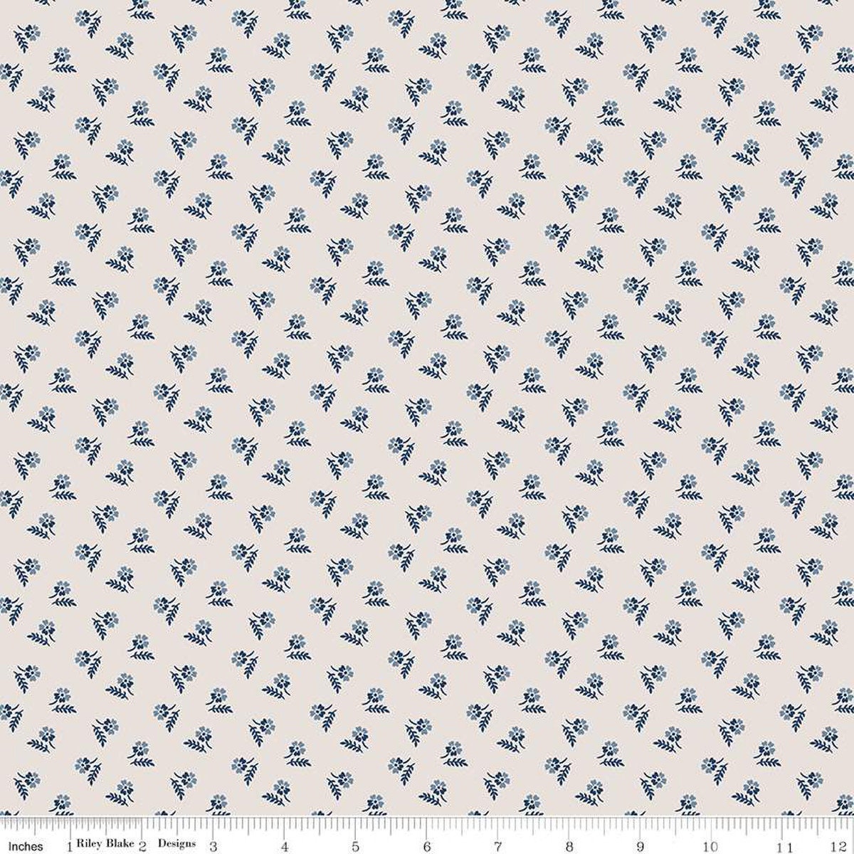 Image of the Serenity Blues Tiny Floral Beige quilting cotton fabric by Gerri Robinson for Riley Blake Designs. Features scattered blossoms and sprigs of leaves on a light tan beige background. 
Cute Little Fabric Shop