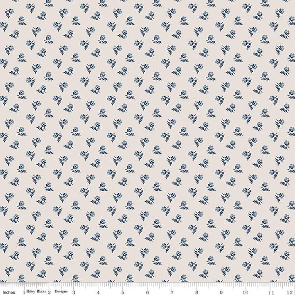 Image of the Serenity Blues Tiny Floral Beige quilting cotton fabric by Gerri Robinson for Riley Blake Designs. Features scattered blossoms and sprigs of leaves on a light tan beige background. 
Cute Little Fabric Shop