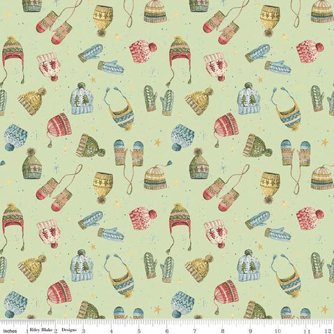 Image of the Magical Winterland Knitwear Green quilting cotton fabric by Riley Blake Designs. Features tossed hats and mittens on a light green background. 
Cute Little Fabric Shop