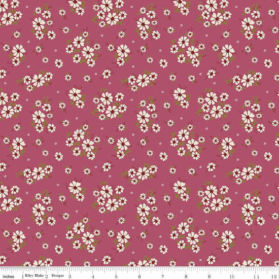Image of the Autumn Afternoon Daisies Wine quilting cotton fabric by Heather Peterson for Riley Blake Designs. Features clusters of white flowers with green leaves on an purple background. 
Cute Little Fabric Shop