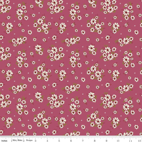 Image of the Autumn Afternoon Daisies Wine quilting cotton fabric by Heather Peterson for Riley Blake Designs. Features clusters of white flowers with green leaves on an purple background. 
Cute Little Fabric Shop