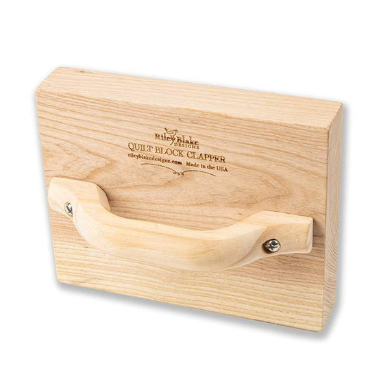 Image of the Riley Blake Designs Quilt Block Clapper. Features a clapper made of hardwood used with a steam iron to set and flatten seams. The size is 8" x 10" and the handle can be attached to the top for everyday use.
Cute Little Fabric Shop