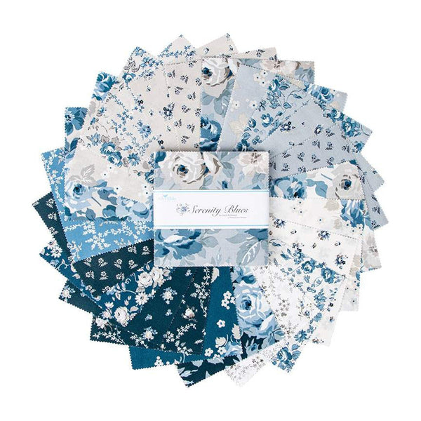 Image of the Serenity Blues 5 inch stacker by Gerri Robinson for Riley Blake Designs. Pictures the main grey fabric with large blue and white roses on a grey background. 
Cute Little Fabric Shop