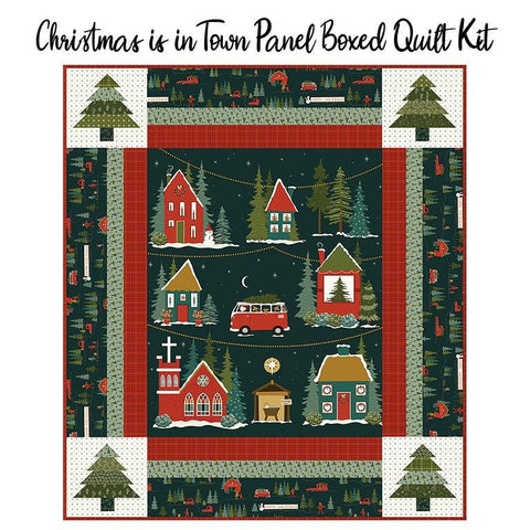 Image of the Christmas is in Town Panel Boxed Quilt Kit. Features a truck and snowy houses with trees in the corners. 
Cute Little Fabric Shop