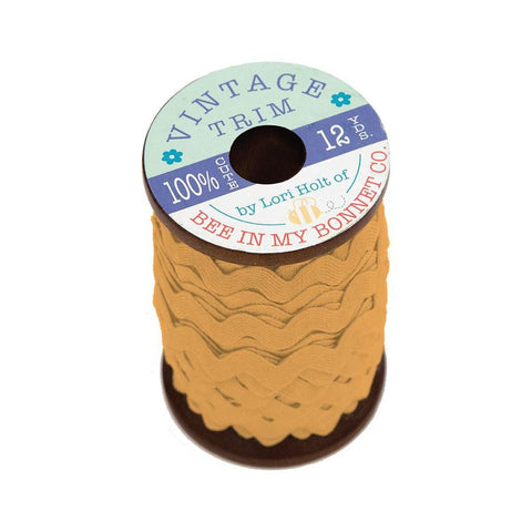 Image of the Lori Holt Vintage Trim Small Cider Wooden Spool by Riley Blake Designs. Features a light orange cider spool of wavy trim on a small wooden spool. 
Cute Little Fabric Shop