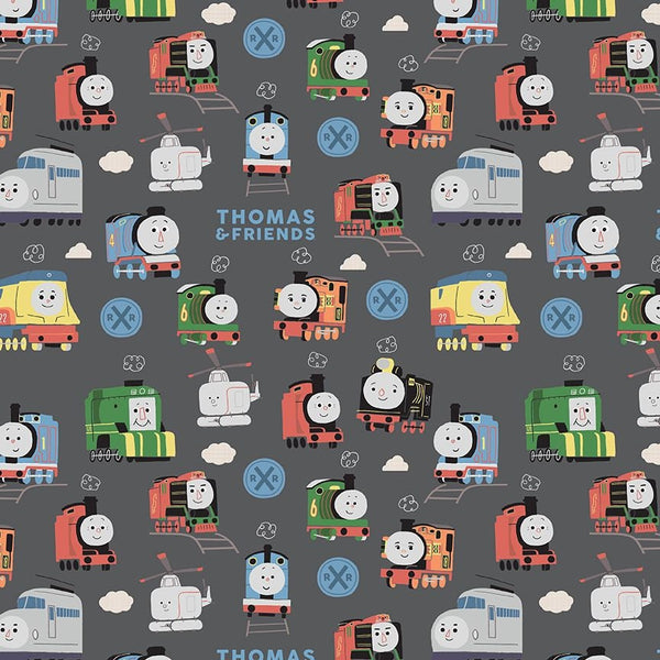 Image of the Thomas & Friends™ Sodor Railway Main Charcoal quilting cotton fabric by Riley Blake Designs. Features scattered trains, text, and icons on a dark grey background. 
Cute Little Fabric Shop