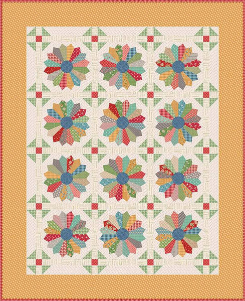 Image of the Christmas Pie Lori Holt Pattern from Riley Blake Designs. Pictures dresden blocks on a light background with a yellow border. 
Cute Little Fabric Shop