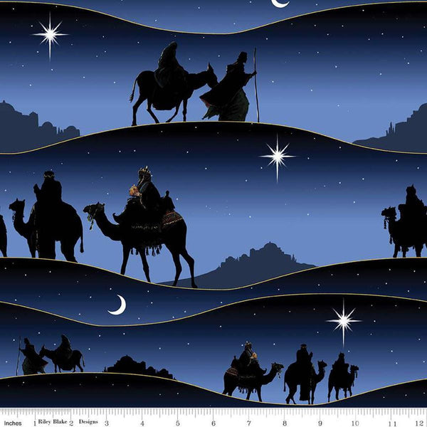 Image of the Christmas Wishes Border Print Navy quilting cotton fabric by Riley Blake Designs. Features the wisemen following the star on a blue background. 
Cute Little Fabric Shop