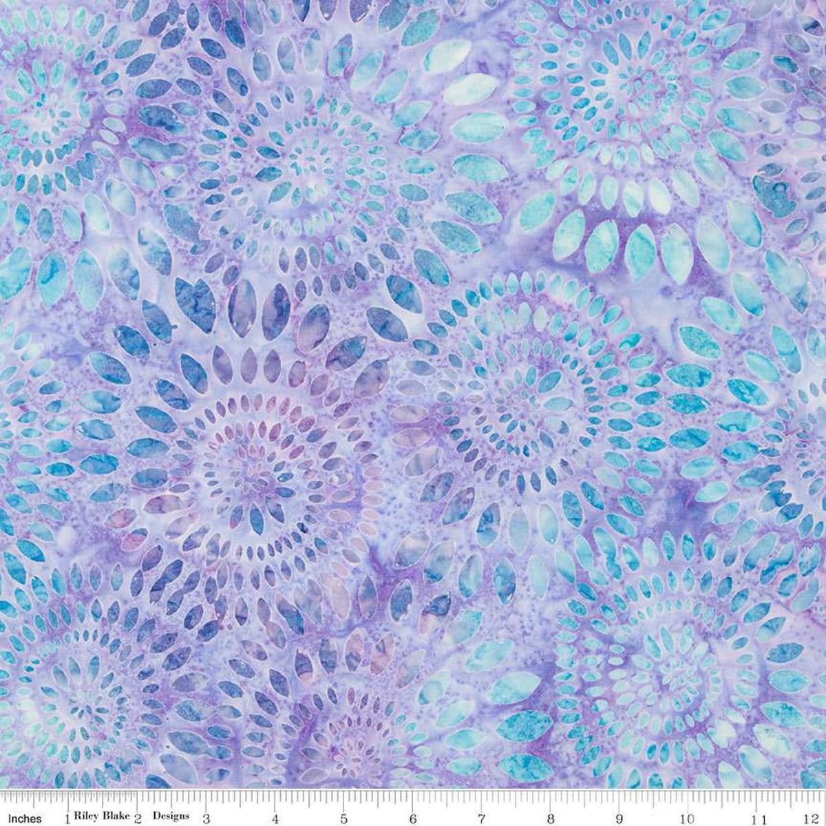 Image of the Wide Back Expressions Batiks Dahlias Wisteria Skye Riley Blake Designs quilting cotton fabric. Features swirls of blue on a light purple color. 
Cute Little Fabric Shop