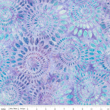 Image of the Wide Back Expressions Batiks Dahlias Wisteria Skye Riley Blake Designs quilting cotton fabric. Features swirls of blue on a light purple color. 
Cute Little Fabric Shop