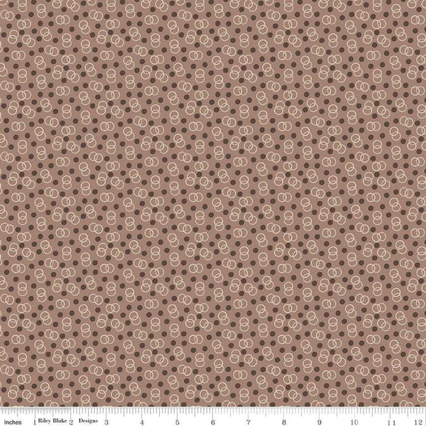 Image of the Mansfield Park Admiral quilting cotton fabric by Riley Blake Designs. Features interlocking circles and dots scattered on a brown background. 
Cute Little Fabric Shop