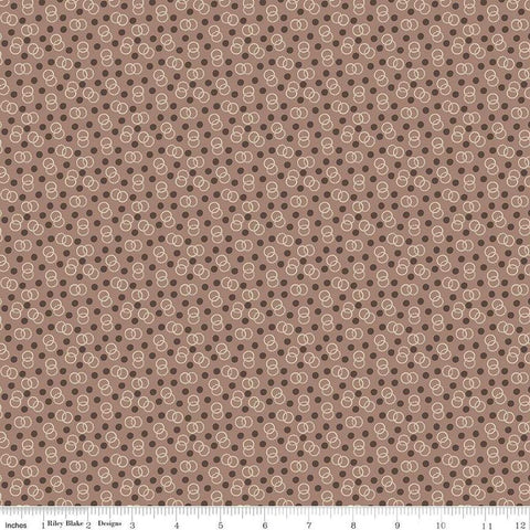 Image of the Mansfield Park Admiral quilting cotton fabric by Riley Blake Designs. Features interlocking circles and dots scattered on a brown background. 
Cute Little Fabric Shop