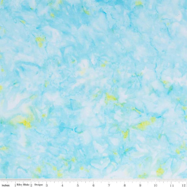 Image of the Wide Back Expressions Batiks Hand-Dyes Light Turquoise Green Multi Batik fabric by Riley Blake Designs. Features a light blue fabric with bright green spots. 
Cute Little Fabric Shop