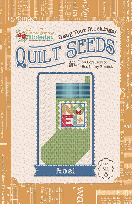Image of the Lori Holt Home Town Holiday Quilt Seeds™ No. 3 by Riley Blake Designs. Features the word "noel" on a stocking. 
Cute Little Fabric Shop