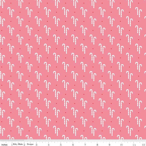 Image of the Cozy Christmas Candy Cane Pink quilting cotton fabric by Riley Blake Designs. Features white candy canes on a pink background. 
Cute Little Fabric Shop