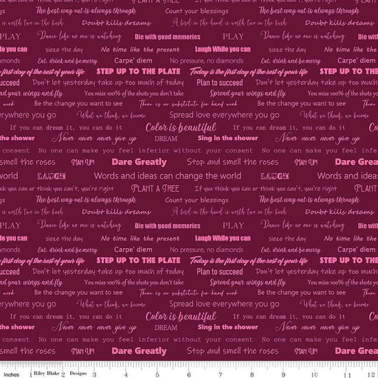 Image of the Fragrant Fields Script Maroon quilting cotton fabric by Lila Tueller for Riley Blake Designs. Features positive phrases on a dark pink purple background. 
Cute Little Fabric Shop