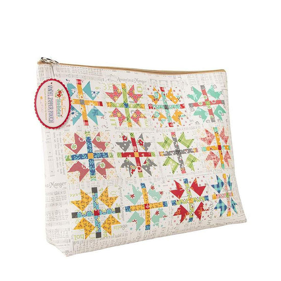 Image of the Lori Holt Home Town Holiday Vinyl Project Bag by Riley Blake Designs. Features a quilt cheater print pattern on a cream colored bag. 
Cute Little Fabric Shop
