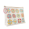 Image of the Lori Holt Home Town Holiday Vinyl Project Bag by Riley Blake Designs. Features a quilt cheater print pattern on a cream colored bag. 
Cute Little Fabric Shop