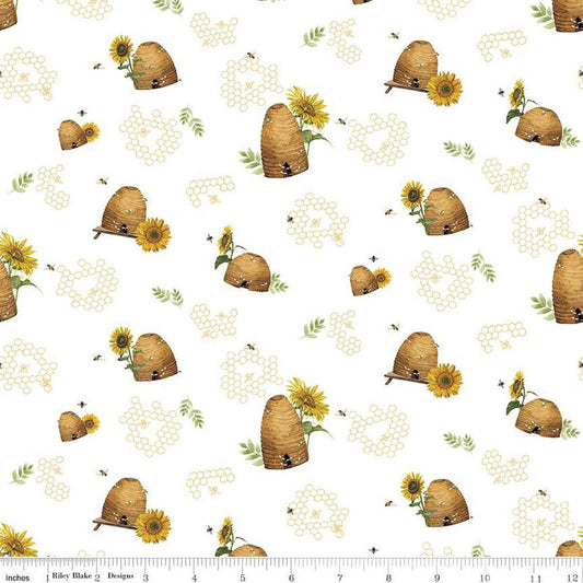 Image of the Honey Bees and Flowers Please Beehives White quilting cotton fabric by Tara Reed for Riley Blake Designs. Features  beehives, bees, honeycomb, and sunflowers on a white background. 
Cute Little Fabric Shop