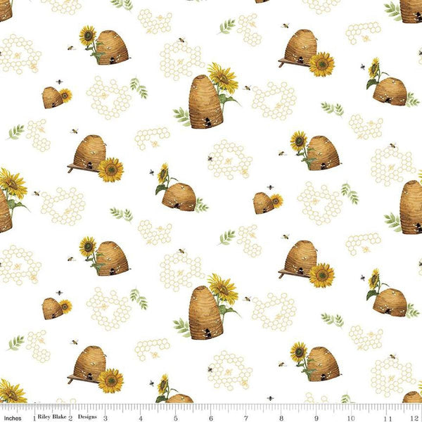 Image of the Honey Bees and Flowers Please Beehives White quilting cotton fabric by Tara Reed for Riley Blake Designs. Features  beehives, bees, honeycomb, and sunflowers on a white background. 
Cute Little Fabric Shop