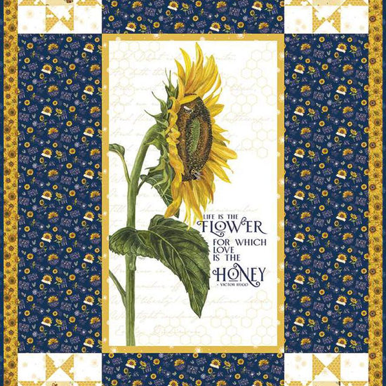 Image of the Life Is the Flower Panel Boxed Quilt Kit by Tara Reed for Riley Blake Designs. Features a large sunflower in the center with coordinating navy and yellow fabrics on the side. 
Cute Little Fabric Shop