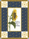 Image of the Life Is the Flower Panel Boxed Quilt Kit by Tara Reed for Riley Blake Designs. Features a large sunflower in the center with coordinating navy and yellow fabrics on the side. 
Cute Little Fabric Shop