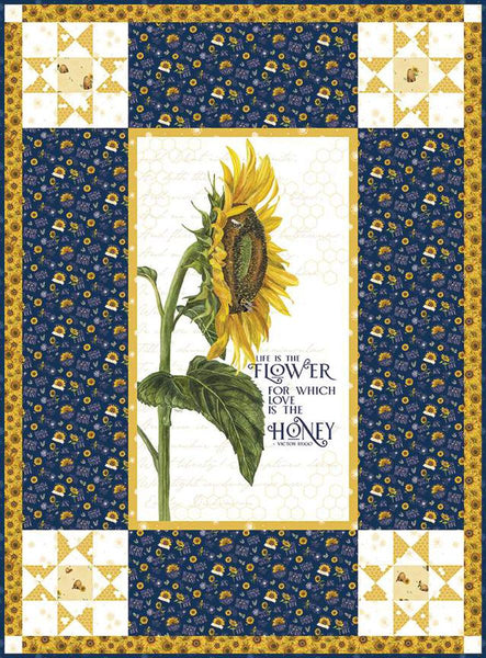 Image of the Life Is the Flower Panel Boxed Quilt Kit by Tara Reed for Riley Blake Designs. Features a large sunflower in the center with coordinating navy and yellow fabrics on the side. 
Cute Little Fabric Shop