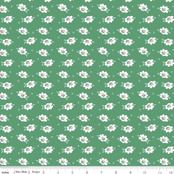 Image of the Always in Season Daisy Green quilting cotton fabric by American Jane for Riley Blake Designs. Features scattered blossoms and dots on a green background. 
Cute Little Fabric Shop