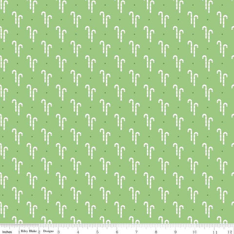 Image of the Cozy Christmas Candy Cane Green quilting cotton fabric by Riley Blake Designs. Features white candy canes on a green background. 
Cute Little Fabric Shop