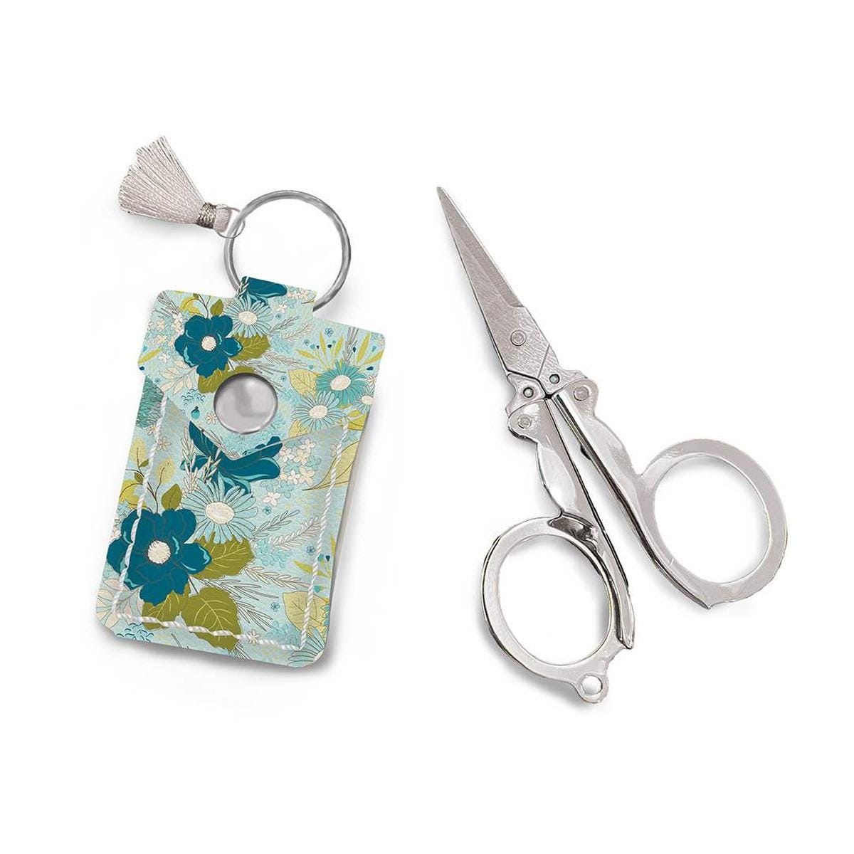 Image of the Leather Scissor Pouch Feed My Soul by Sandy Gervais for Riley Blake Designs. Features a blue case with flowers on it. 
Cute Little Fabric Shop