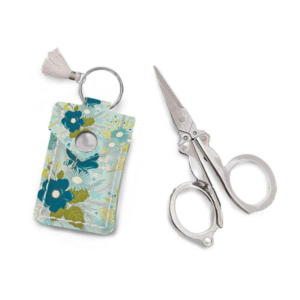 Image of the Leather Scissor Pouch Feed My Soul by Sandy Gervais for Riley Blake Designs. Features a blue case with flowers on it. 
Cute Little Fabric Shop