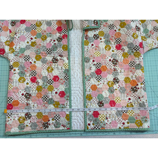 Image of the Quilted Jacket Pattern by Paula McKinlay and Claire Root. Features a jacket with a quilted pattern and a measuring tape showing that it is 15.75 inches wide. 
Cute Little Fabric Shop
