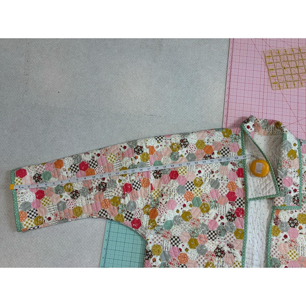 Image of the Quilted Jacket Pattern by Paula McKinlay and Claire Root. Features a jacket with a quilted pattern and a measuring tape showing that the sleeve is 29 inches long. 
Cute Little Fabric Shop