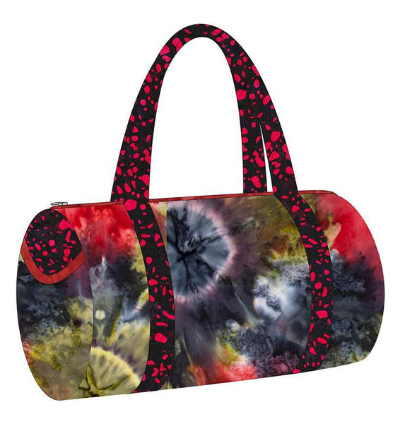 Image of the Melissa Mortenson Saturday Duffle Bag Pattern. Features a round, lined zippered duffle bag with an optional exterior pocket and a detachable shoulder strap. 
Cute Little Fabric Shop