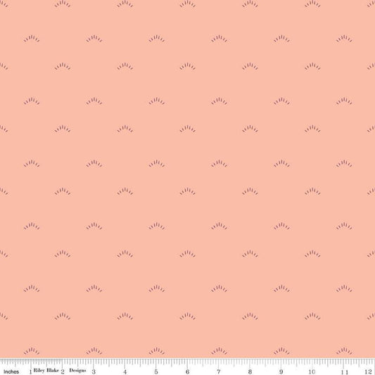 Image of the Garden Dreams Shimmer Peaches 'n Cream quilting cotton fabric by Amber Elliot for Riley Blake Designs. Features eyelash shapes scattered on a light pink coral background. 
Cute Little Fabric Shop