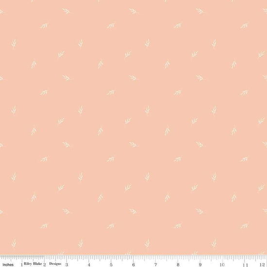 Image of the Garden Dreams Leaf Toss Peaches 'n Cream quilting cotton fabric by Amber Elliot for Riley Blake Designs. Features leaves scattered on a light pink orange background. 
Cute Little Fabric Shop