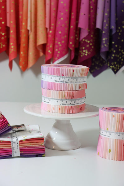 Image of the I Heart Ombre Jelly Roll by Moda Fabrics. Features pink, coral, purple, and cream fabrics. 
Cute Little Fabric Shop