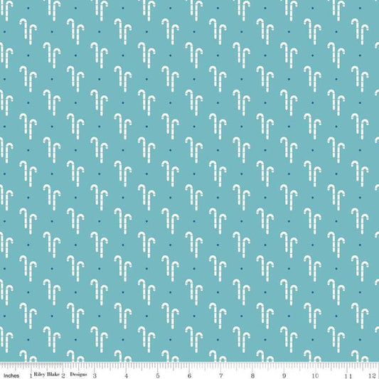 Image of the Cozy Christmas Candy Cane Blue quilting cotton fabric by Riley Blake Designs. Features white candy canes on a blue background. 
Cute Little Fabric Shop