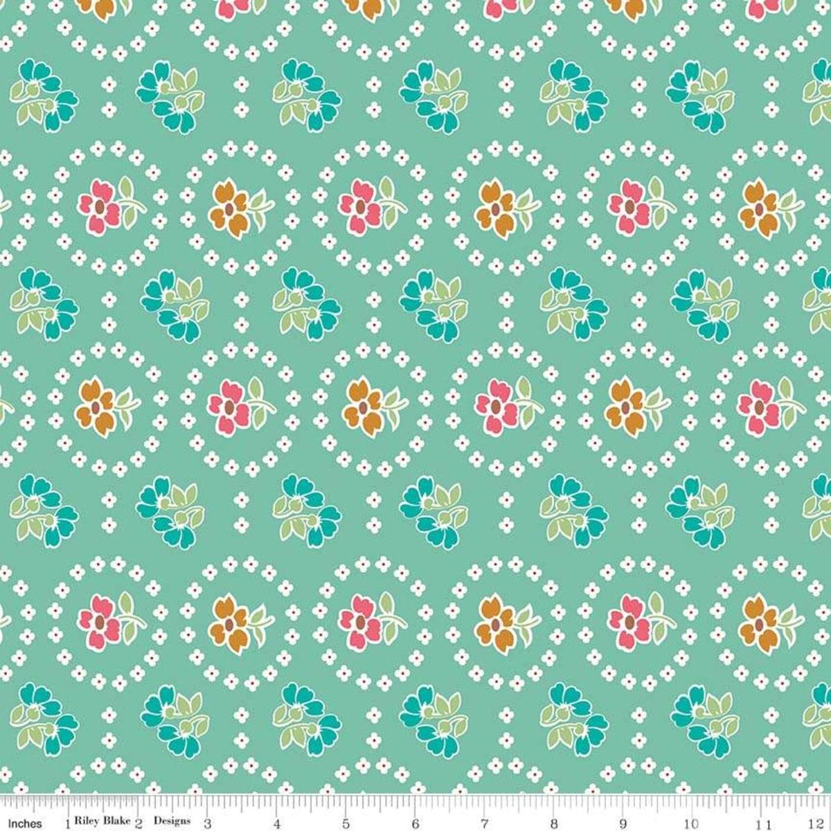 Image of the Granny Chic Curtains Teal quilting cotton fabric by Lori Holt for Riley Blake Designs. Features a flower bordered by a circle of small white flowers on a mint background. 
Cute Little Fabric Shop