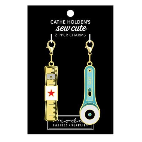Image of the Sew Cute Zipper Charm Measure Cut by Cathe Holden for Moda Fabrics. Features a measuring tape and rotary blade charm. Set of two on lobster clasps. 
Cute Little Fabric Shop